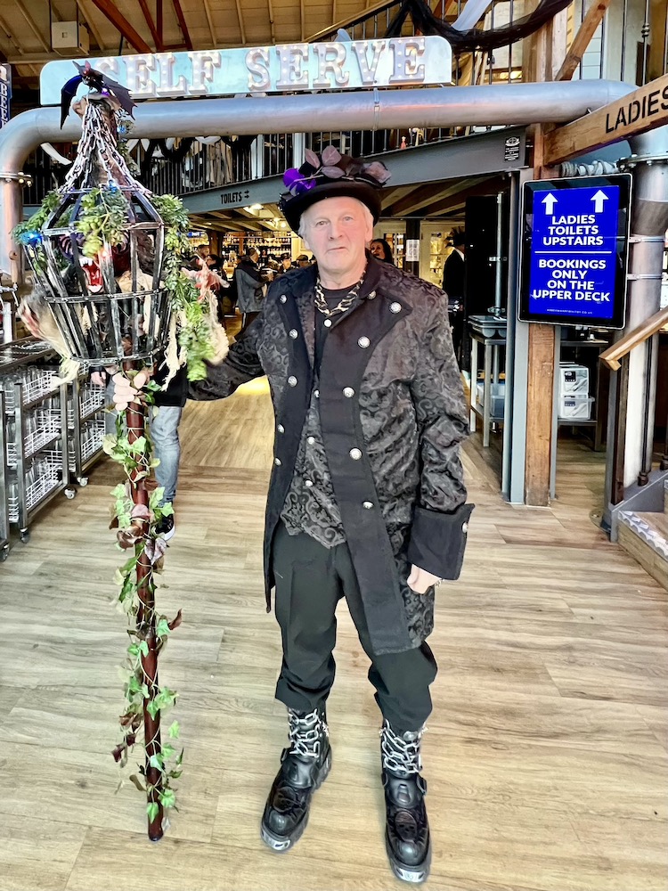 Man with a stick in Goth weekend in Whitby