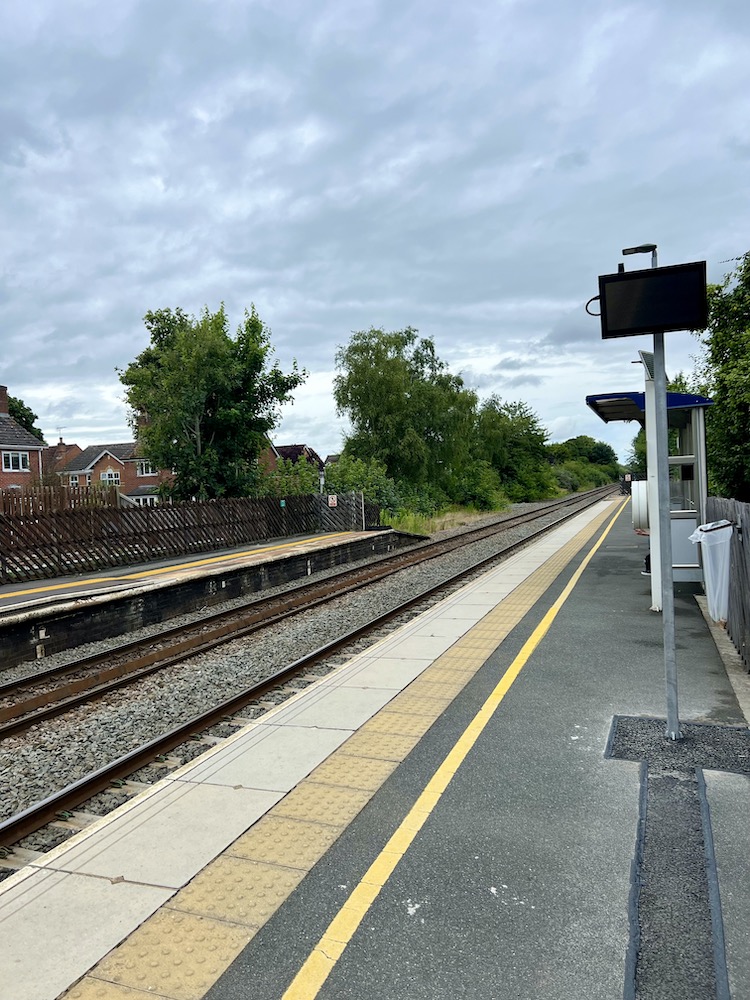 Train tracks and train station in an English village