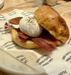 a picture of a brioche bun with an egg and bacon in a wrap